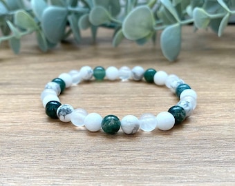 May include: A white and green beaded bracelet with white and green stones. The bracelet is made of natural stones and is perfect for everyday wear.