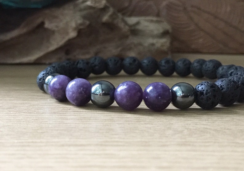 Close-up of lepidolite, hematite, and lava rock beads showing natural stone texture