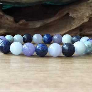 May include: A bracelet made of blue, purple and light blue gemstone beads.