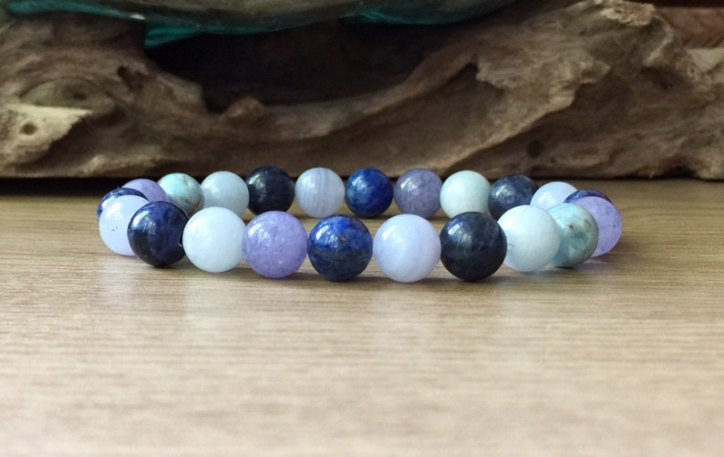 May include: A bracelet made of blue, purple and light blue gemstone beads.
