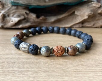 May include: A beaded bracelet featuring black lava rock, a silver Buddha bead, a brown wood bead, and gold pyrite beads.