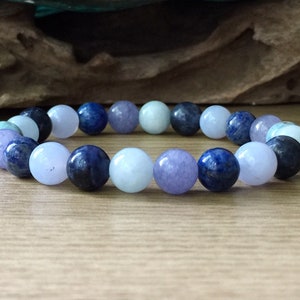May include: A bracelet made of blue, light blue, and purple gemstone beads.