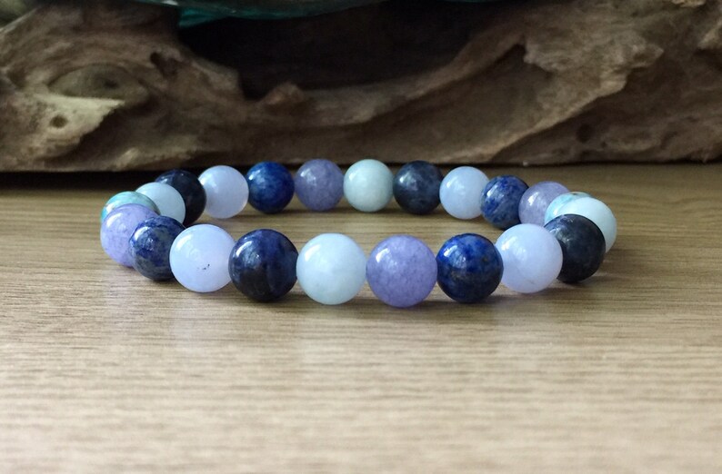 May include: A bracelet made of blue, light blue, and purple gemstone beads.