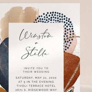 May include: Wedding invitation with abstract watercolor shapes in shades of blue, brown, and pink. The text reads "Winston + Stella" and includes the date, time, and location of the wedding.