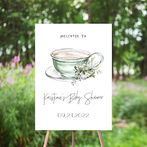 Pode incluir: Um sinal de boas-vindas ao Chuveiro de Bebê da Kristina com uma ilustração em aquarela de uma xícara de chá verde com um pires e vegetação. A data do evento é 09.21.2022.