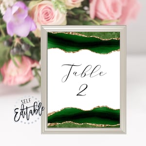 May include: A printable table number card with a green and gold agate design. The card says "Table 2" in black script.