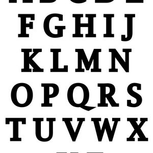 May include: Black and white image of the alphabet in a bold, blocky font.
