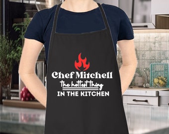 Custom Name The Hottest Thing In The Kitchen - Grill Apron - Personalized Apron - Funny Grill Apron, Wedding Gift, Newlywed, Anniversary