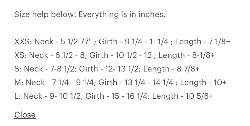 May include: Size chart for a garment, showing neck and girth measurements in inches for sizes XXS, XS, S, M, and L.  The chart also includes length measurements in inches.