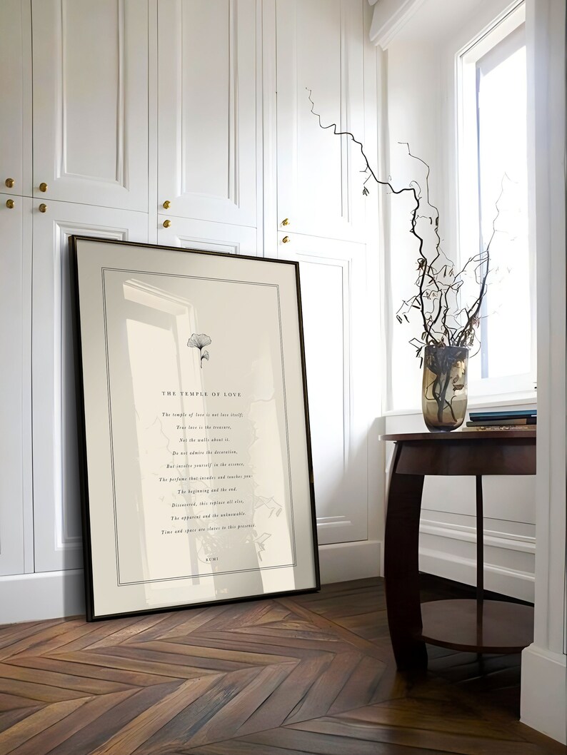 May include: A framed print with a black and white illustration of a tree and a quote by Rumi. The quote reads "The temple of love is not love itself. True love is in the devotion. Not the walls about it. Do not admire the decoration. But rather yourself in the mirror. The perfume that ascends and reaches you. The beginning and the end. Discovered, this replaces all else. The apparent and the unobservable. Time and space are absent in this presence. Rumi"
