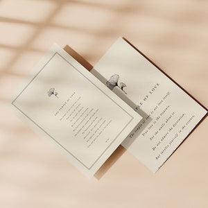 May include: Two cards with a minimalist design featuring a black and white illustration of a ginkgo leaf. The text on the cards reads "The temple of love is not love itself; True love is the treasure, Not the walls about it. Do not admire the decoration, But invoice yourself in the essence."