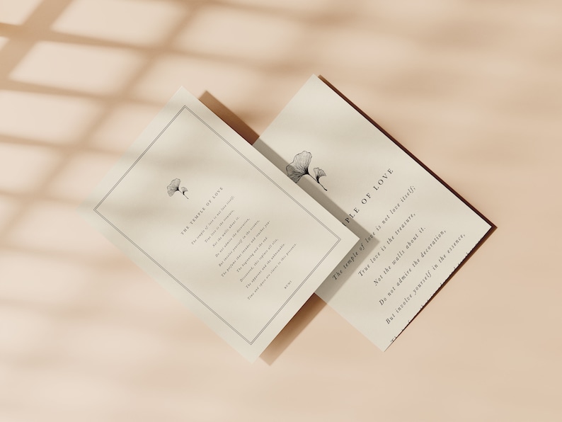 May include: Two cards with a minimalist design featuring a black and white illustration of a ginkgo leaf. The text on the cards reads "The temple of love is not love itself; True love is the treasure, Not the walls about it. Do not admire the decoration, But invoice yourself in the essence."