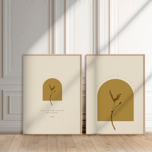 May include: Two framed prints with a beige background and a gold arch. The arch contains a brown pressed flower. The text below the arch reads "Love is the bridge between you and everything." Rumi.