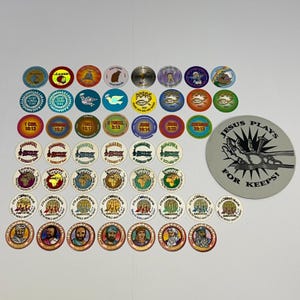 May include: A collection of colourful, circular religious tokens and a larger grey token. The tokens feature various designs, including text, doves, fish symbols, and images of biblical figures. The larger token reads "JESUS PLAYS FOR KEEPS!"