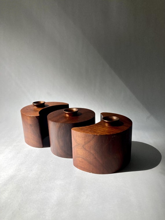 Walnut candleholder carved into an abstract moon-and-sun form — Danish minimalism meets celestial sculpture in a single object.