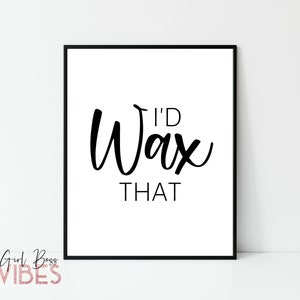 May include: A framed white print with the words "I'D Wax THAT" in black script. The phrase is centered on the white background. The words "Girl Boss VIBES" are in pink script at the bottom left corner.