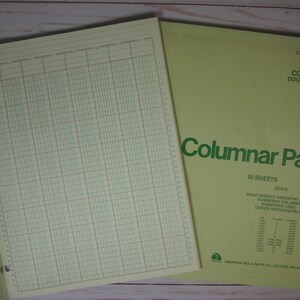 May include: Open columnar pad with green grid lines and a yellow cover. The cover reads "Columnar Pad" with "12 Columns Double Page" and "50 Sheets 11X8 1/2". The pad is designed for detailed record-keeping and data organization.