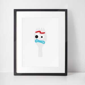 May include: A black framed print of a white fork with a blue eye, red eyebrow, and blue mouth. The fork is a character from the movie Toy Story.