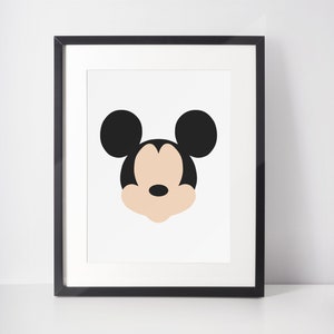 May include: Black and white framed print of a cartoon Mickey Mouse head with a peach colored face.