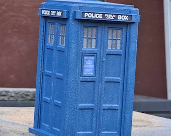 May include: A blue police call box with a sign that reads "Police Public Call Box".