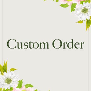 May include: A rectangular sign with a light beige background and a thin dark border. The text "Custom Order" is printed in dark green in the center. The top right and bottom left corners are decorated with pink roses, white daisies, and green leaves.