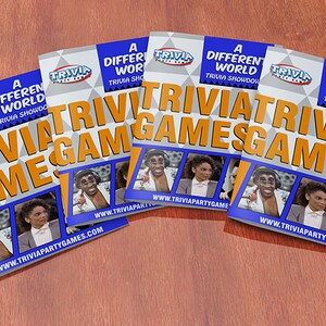 May include: Four blue and orange game cards with the text "A Different World Trivia Showdown!" and "Trivia Games" on them. The cards feature photos of the cast of the television show "A Different World".