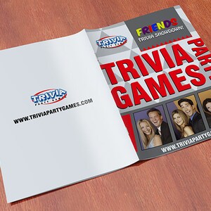 May include: A red, white, and gray trivia game booklet with the title "FRIENDS TRIVIA SHOWDOWN! TRIVIA PARTY GAMES" and a photo of the cast of the TV show "Friends". The website www.triviapartygames.com is printed on the front cover.