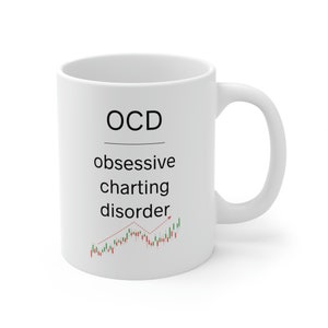 May include: White ceramic mug featuring the text "OCD obsessive charting disorder" in black. A red and green stock chart graphic is below the text. The mug has a curved handle.
