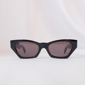 Vintage Versace Mod 477/A sunglasses with black frame and silver Medusa logos, 90s Gianni Versace luxury design.