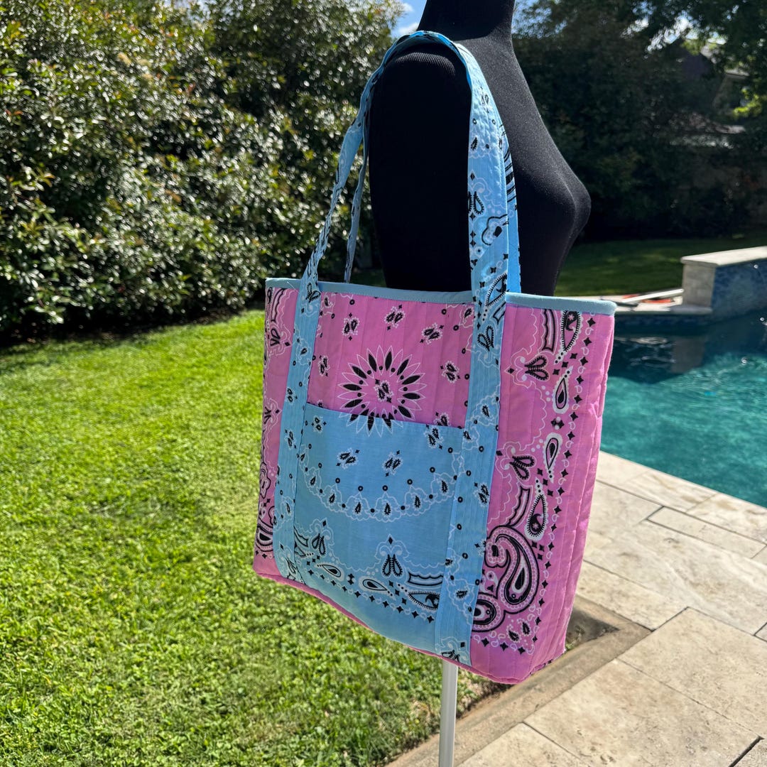A quilted bandana tote bag featuring pink and blue hues, perfect for adding a pop of color to any outfit