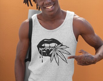 May include: A light gray tank top featuring a black graphic of lips with dripping liquid and a cannabis leaf. The tank top is worn by a person with dreadlocks and a nose ring, smiling in front of an orange background.