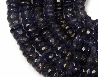 May include: A strand of dark blue faceted gemstone beads. The beads are small and round, and they have a slightly irregular shape. The beads are strung on a clear thread.