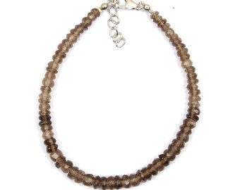 May include: A brown smoky quartz beaded bracelet with a silver clasp.