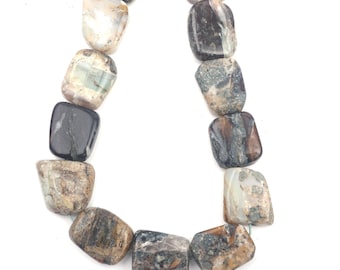 May include: A strand of polished gemstone beads. The beads are rectangular with rounded edges and feature a mix of colors including brown, gray, black, and cream. The beads are strung together, creating a necklace or bracelet.