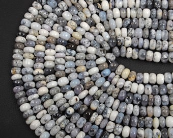 May include: A strand of white and gray opal beads. The beads are round and have a smooth, polished finish. The beads are strung on a white cord.