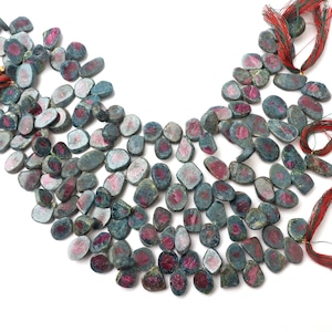 May include: A strand of green and pink ruby gemstone beads. The beads are irregularly shaped and have a natural, rough finish.