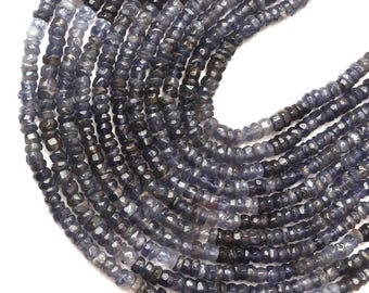 May include: Strands of faceted, dark blue-gray gemstone beads. The beads are small, with a slightly irregular shape, and are strung together to form a necklace or bracelet. The beads have a subtle sparkle and a polished finish.