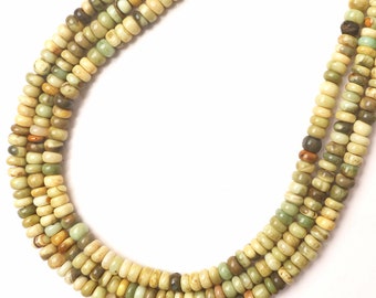 May include: A strand of green, brown, and cream colored gemstone beads. The beads are round and have a smooth, polished finish.