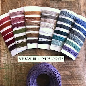 May include: A selection of 37 different colors of twine, displayed on cards, with the text "37 BEAUTIFUL COLOR CHOICES". A single ball of purple twine is in the foreground.