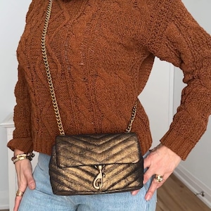 May include: A set of three ceramic mugs with a speckled, matte finish. The mugs are in shades of cream, light gray, and dark gray. Each mug has a simple, minimalist design, perfect for coffee or tea.