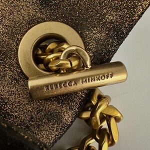 May include: A white ceramic mug with a black handle and the text "But First, Coffee" in a black, handwritten-style font. The mug is on a white surface.