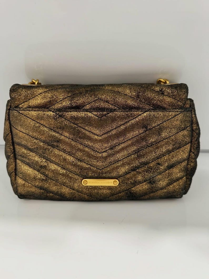 May include: A set of three ceramic mugs with a speckled, matte finish. The mugs are in shades of cream, light gray, and dark gray. Each mug has a simple, minimalist design and a rounded handle.