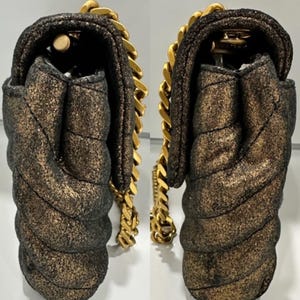 May include: A white ceramic mug with a black handle and the text "But First, Coffee" in a black, handwritten-style font. The mug is on a white surface.