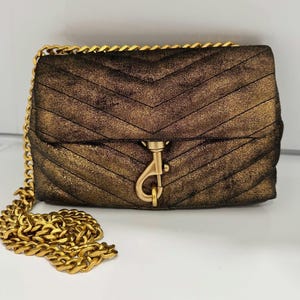 May include: A set of three ceramic mugs with a speckled, matte finish. The mugs are in shades of cream, light gray, and dark gray. Each mug has a simple, minimalist design, perfect for coffee or tea.