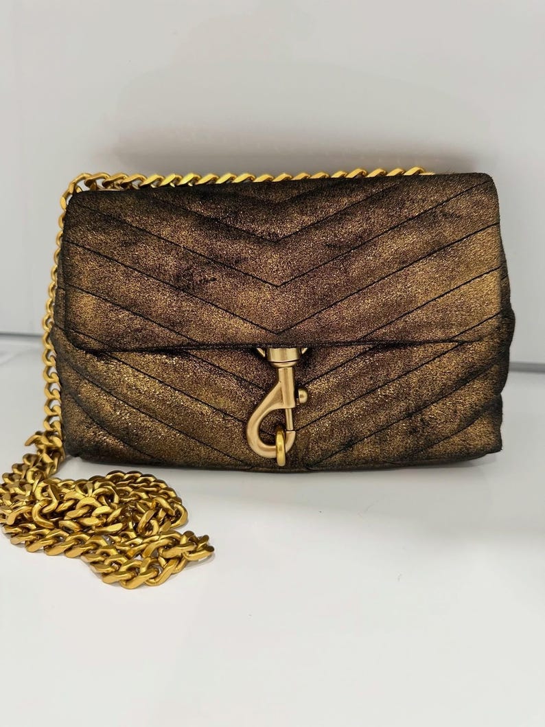 May include: A set of three ceramic mugs with a speckled, matte finish. The mugs are in shades of cream, light gray, and dark gray. Each mug has a simple, minimalist design, perfect for coffee or tea.