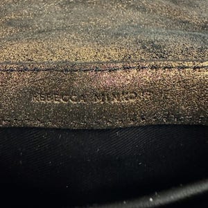 May include: A set of three ceramic mugs with a speckled, matte finish. The mugs are in shades of cream, light gray, and dark gray. Each mug has a simple, minimalist design, perfect for coffee or tea.