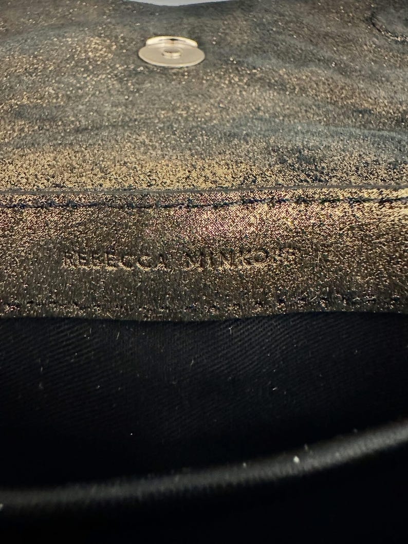 May include: A set of three ceramic mugs with a speckled, matte finish. The mugs are in shades of cream, light gray, and dark gray. Each mug has a simple, minimalist design, perfect for coffee or tea.