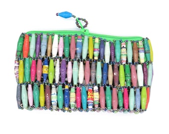 May include: A colorful zippered pouch made of rolled paper beads. The beads are in various shades of green, blue, pink, purple, and yellow. The pouch has a green zipper and a blue bead on the zipper pull.