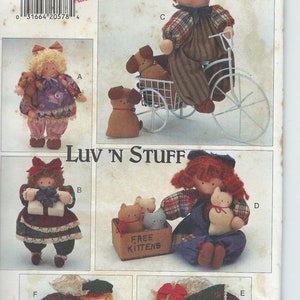 May include: A vintage sewing pattern for making a variety of stuffed toys. The pattern includes instructions for making a boy doll riding a tricycle, a girl doll holding a cat, a girl doll holding a present, and two angel dolls. The pattern is titled "Luv 'N Stuff" and is from Butterick.