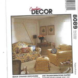 May include: A magazine cover with the title "Creative Decor" featuring a room with slipcovered furniture. The furniture includes a floral-patterned sofa, a yellow plaid armchair, and a matching ottoman. Text at the bottom promotes quick change slipcovers.